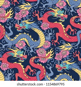 Blue and red dragons fighting in pink flowers on dark blue background. Seamless pattern for textile and decoration
