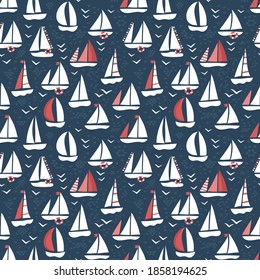 Blue and red seamless pattern with sailboats and white sails. Nice backdrop or wallpaper for boy. Childish apparel design. Dark blue sea with seagulls, waves.