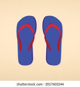 Blue with red striped flip flops on beach