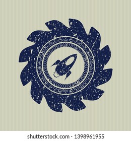 Blue rocket icon inside distressed rubber stamp