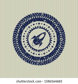 Blue rocket icon inside distressed rubber stamp
