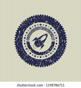 Blue rocket icon inside rubber grunge stamp
