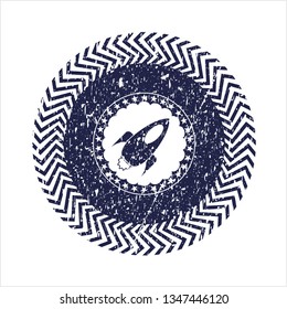 Blue rocket icon inside rubber stamp with grunge texture
