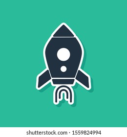 Blue Rocket ship with fire icon isolated on green background. Space travel.  Vector Illustration