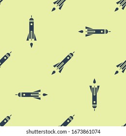Blue Rocket ship with fire icon isolated seamless pattern on yellow background. Space travel.  Vector Illustration