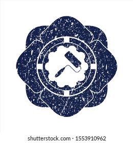 Blue roller brush icon inside distress rubber stamp with grunge texture