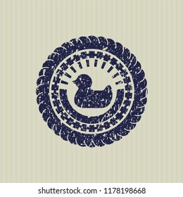 Blue rubber duck icon inside distressed rubber seal with grunge texture