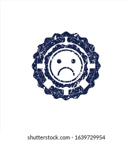 Blue sad face icon inside rubber grunge texture seal