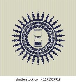 Blue sand clock icon inside distress rubber stamp with grunge texture
