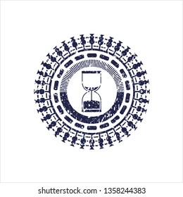 Blue sand clock icon inside rubber seal with grunge texture