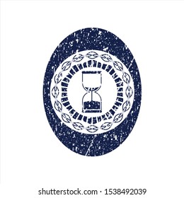 Blue sand clock icon inside distress rubber stamp