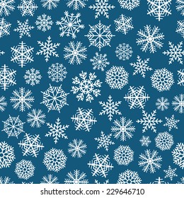 Blue seamless christmas background of flakes