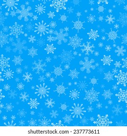 Blue seamless Christmas pattern with different snowflakes falling
