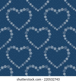 Blue seamless pattern with hearts made of snowflakes.