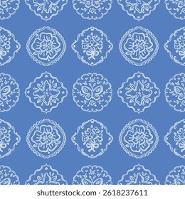 Blue seamless vector pattern with hand-drawn floral and butterfly emblems in circular and diamond frames. Vintage ornamental illustration. Repeating tile design