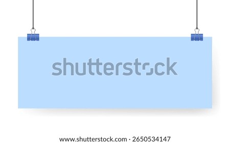 Blue sheet of paper note hanging on binder clip. Long wide banner with panoramic orientation. Light blue background