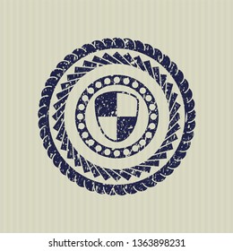 Blue shield, safety icon inside rubber seal with grunge texture