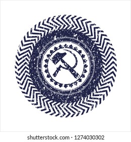 Blue sickle and hammer icon inside distressed rubber stamp with grunge texture