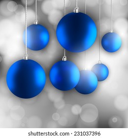 Blue simple Christmas balls on the silver abstract background.