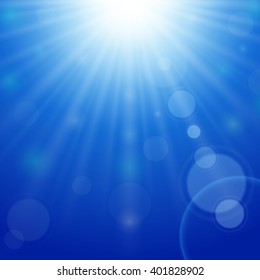 Blue sky background with bright sun and lens flare