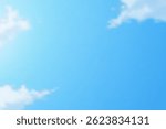 Blue Sky Background. The vast expanse of a clear blue sky is gently punctuated by soft, fluffy clouds, creating a sense of peace and freedom. A visual representation of serenity and boundlessness.