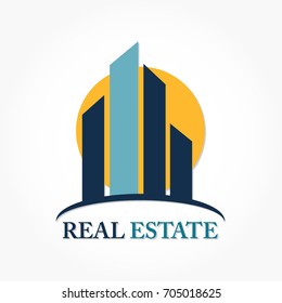 blue sky scraper building with circle sunset behind for Real Estate Logo Design