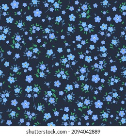 Flores azules esparcidas al azar en un fondo azul oscuro. Patrón vectorial floral