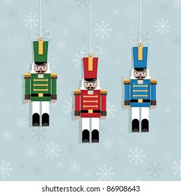 blue snowflake background with hanging christmas nutcracker soldier ornaments