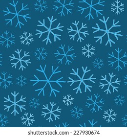Blue  snowflakes on blue background seamless pattern