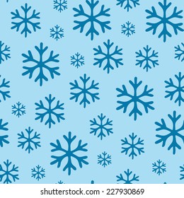 Blue  snowflakes on blue background seamless pattern