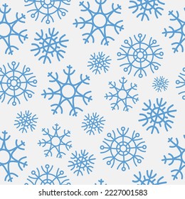 Blue snowflakes on white background. Christmas and new year seamless pattern. For textile, wrapping paper, packaging.