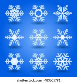 Blue snowflakes and shadow on blue background.