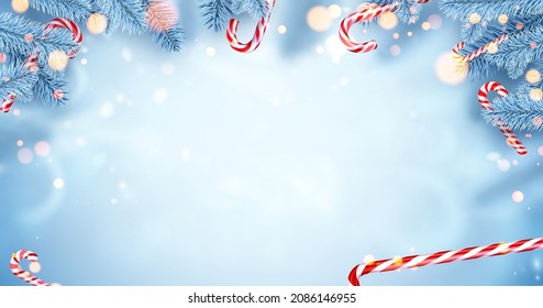 Blue spruce branches with candy canes and bokeh lights. Space for text. Vector holiday illustration.