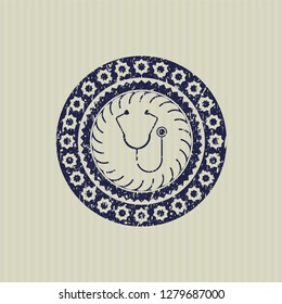 Blue stethoscope icon inside distressed rubber grunge texture seal