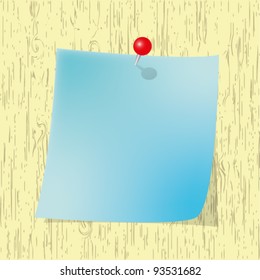 Blue Sticky  note pad with red pin on wooden board.