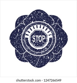 Blue stop icon inside rubber stamp with grunge texture