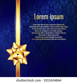 Blue textured background with gold bow. Gift Card with Gold Bow and Gold ribbon. Space for text.