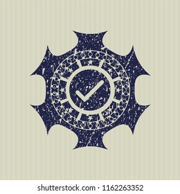Blue tick icon inside distressed rubber grunge stamp