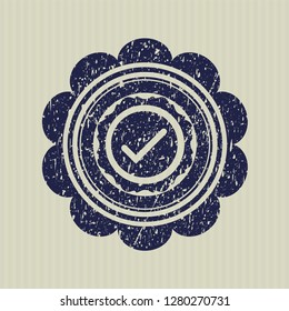 Blue tick icon inside rubber grunge stamp