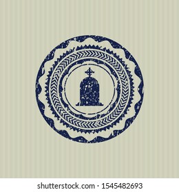 Blue tombstone icon inside rubber seal with grunge texture