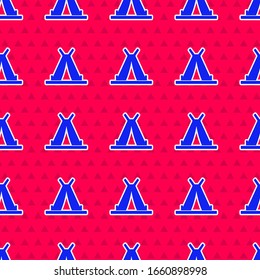 Blue Traditional indian teepee or wigwam icon isolated seamless pattern on red background. Indian tent.  Vector Illustration