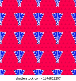 Blue Traditional paper chinese or japanese folding fan icon isolated seamless pattern on red background.  Vector Illustration
