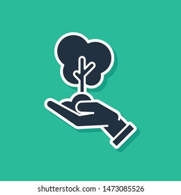 Blue Tree in hand of environmental protection icon isolated on green background. Seed and seedling. Planting sapling. Ecology concept.  Vector Illustration