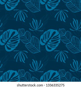Blue tropical leaves pattern. Tropical seamless pattern with white leaves of monstera, banana and palm trees on a blue background.