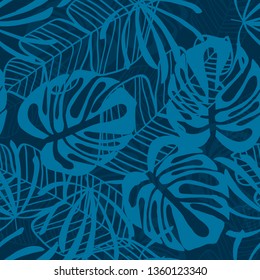 Blue tropical leaves pattern. Tropical seamless pattern with white leaves of monstera, banana and palm trees on a blue background.