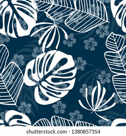 Blue tropical leaves pattern. Tropical seamless pattern with white leaves of monstera, banana and palm trees on a blue background.