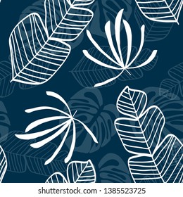 Blue tropical leaves pattern. Tropical seamless pattern with white leaves of monstera, banana and palm trees on a blue background.