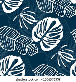 Blue tropical leaves pattern. Tropical seamless pattern with white leaves of monstera, banana and palm trees on a blue background.
