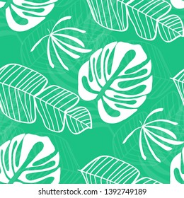 Blue tropical leaves pattern. Tropical seamless pattern with white leaves of monstera, banana and palm trees on a blue background.
