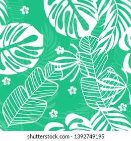 Blue tropical leaves pattern. Tropical seamless pattern with white leaves of monstera, banana and palm trees on a blue background.